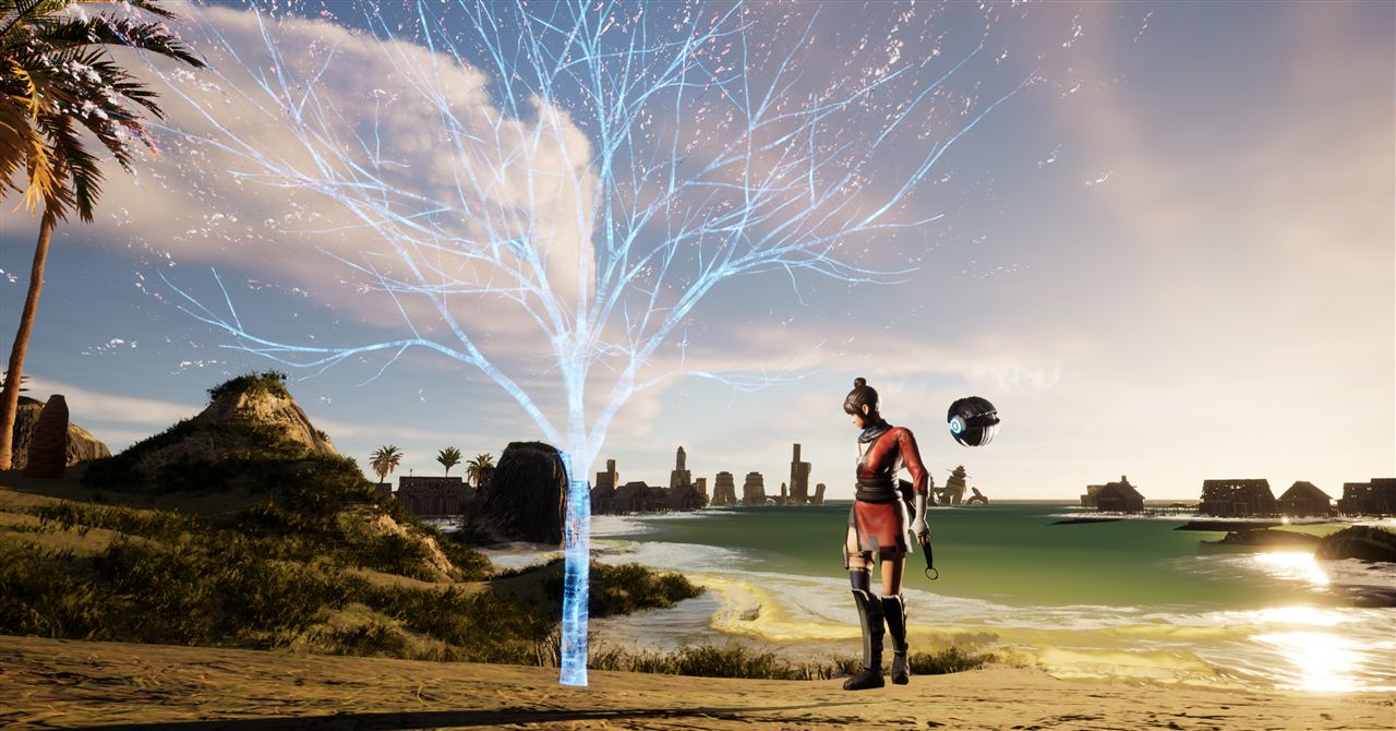 Glowing tree of light on a beach at sunset